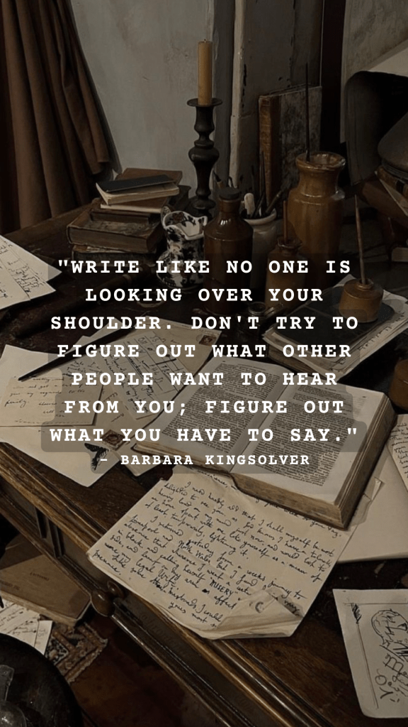 A cluttered writing desk with handwritten notes, books, and a candle, featuring a quote by Barbara Kingsolver.